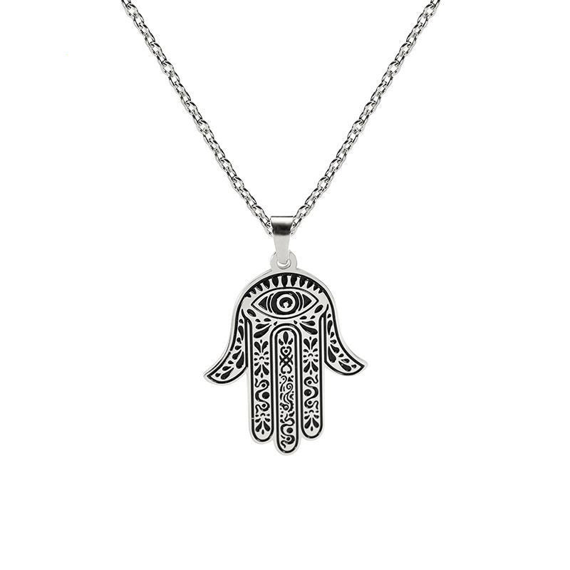 A silver-colored stainless steel Hamsa hand Evil Eye pendant on a chain.