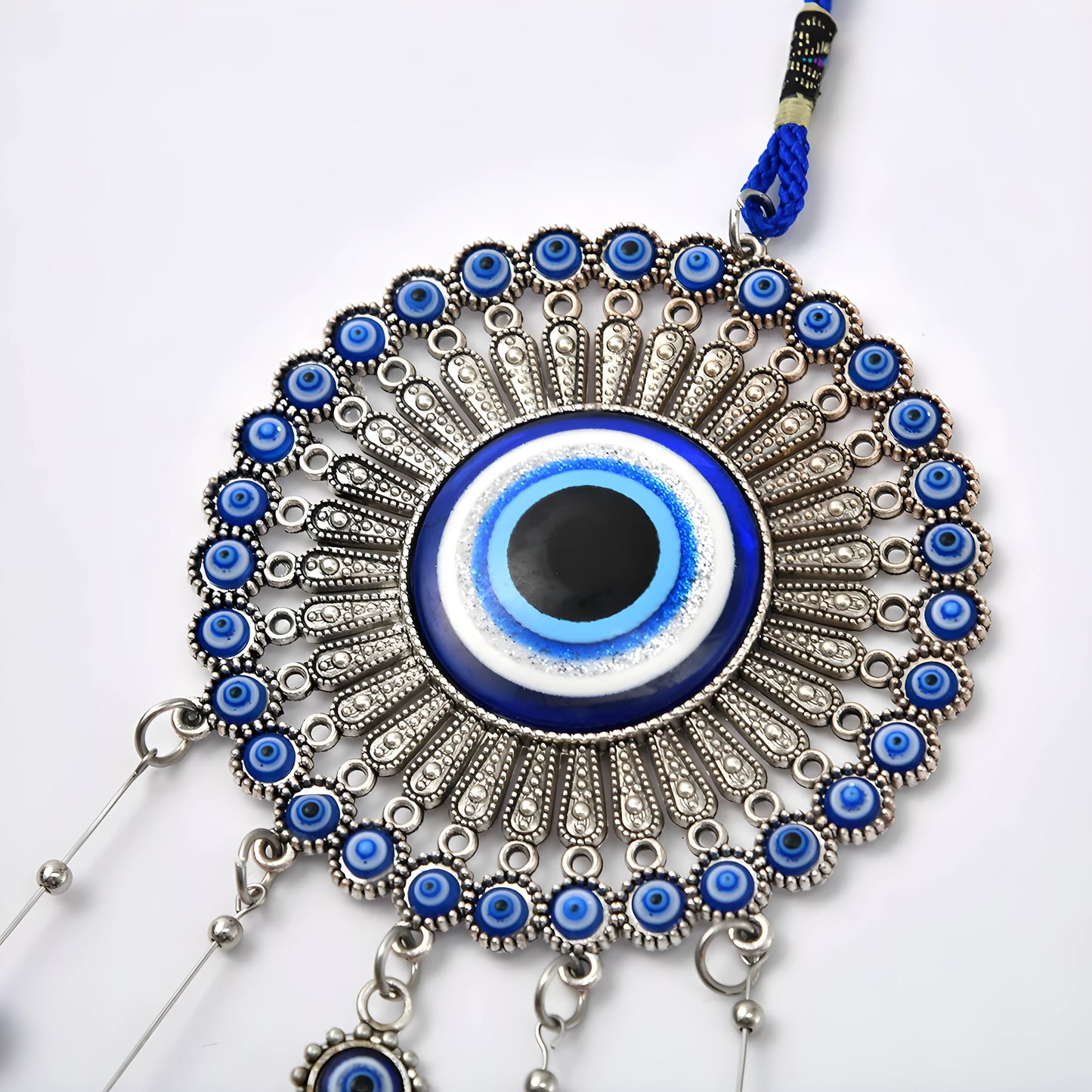 Protective evil eye ornament with bells, perfect for spiritual home decor