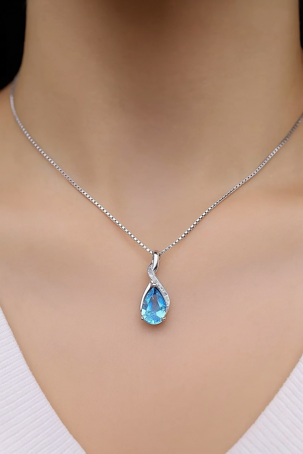 Elegant teardrop blue topaz pendant necklace in sterling silver with cubic zirconia accents on a fine chain – gemstone jewelry gift for women.