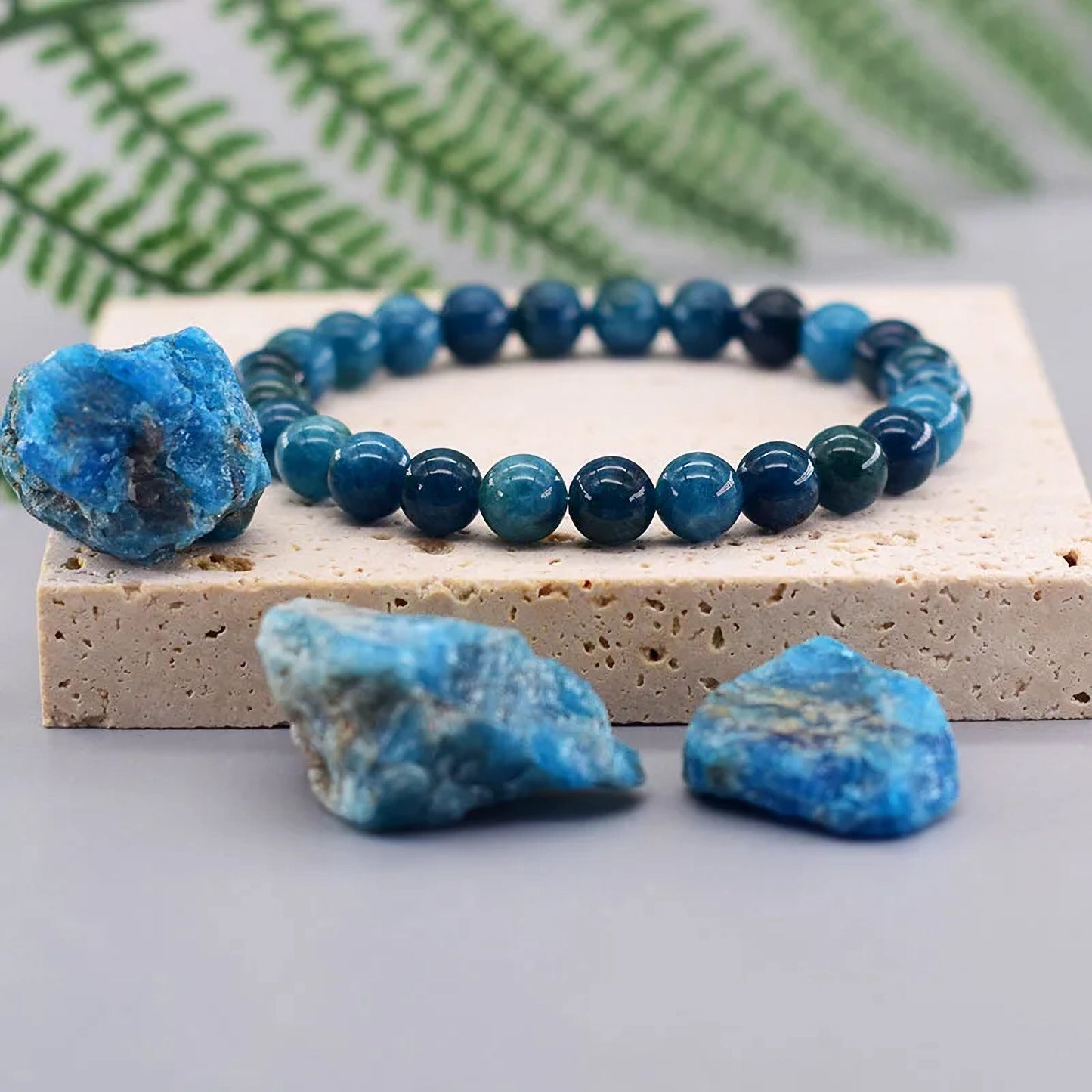 Blue beaded bracelet with blue stones on a white surface