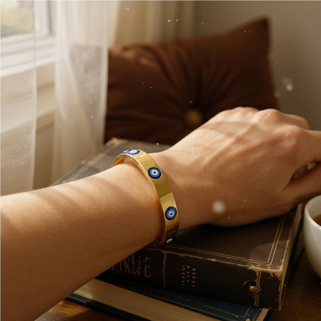 Women’s gold evil eye bangle with intricate design for positive energy