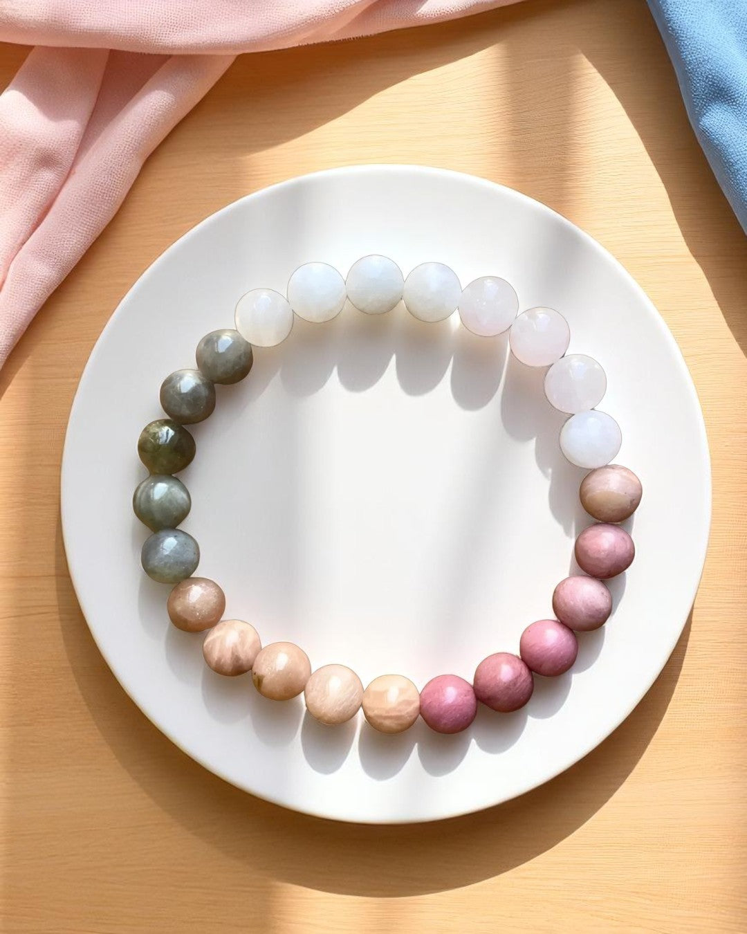 Multicolored beaded bracelet on a white plate with a wooden surface