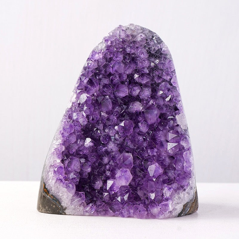 Amethyst crystal cluster on a white background