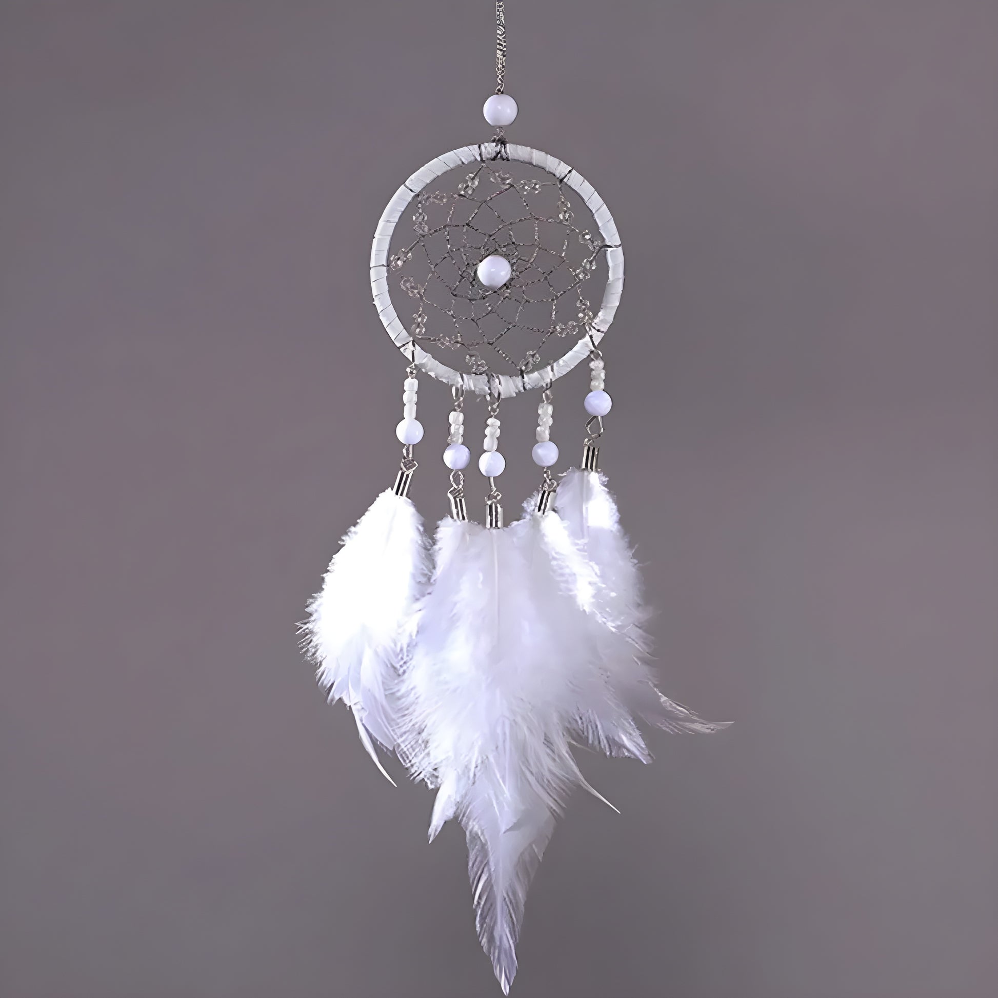 Handmade dream catcher charm hanging from car rearview mirror