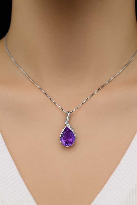 Silver necklace with a purple teardrop pendant on a mannequin
