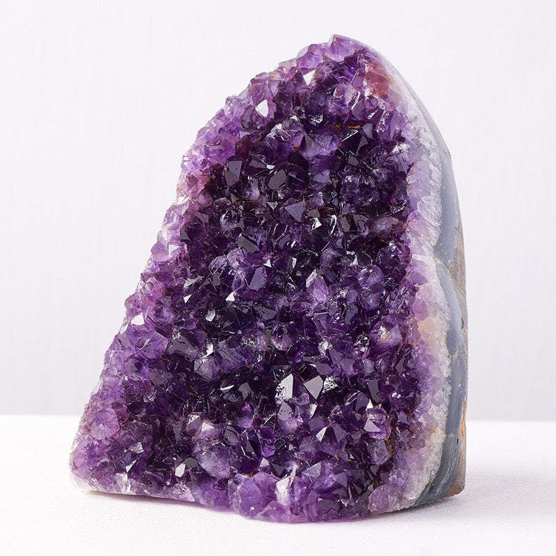 Amethyst crystal cluster on a white background